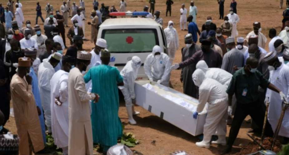 Workers bury Abba Kyari, chief of staff to President Muhammadu Buhari, who died from coronavirus in April.  By Kola Sulaimon AFP