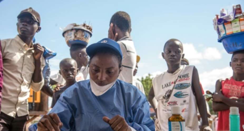 World Health Organization nurses prepare to administer vaccines at the city of Mbandaka on May 21, 2018 during the launch of an Ebola vaccination campaign as the death toll in DR Congo continues to rise.  By JUNIOR KANNAH AFP