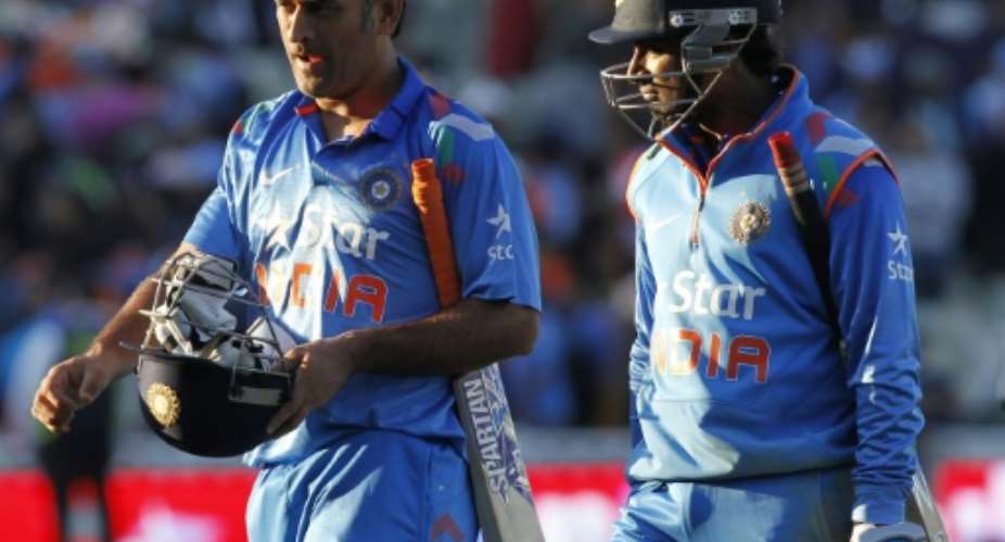 India's Mahendra Singh Dhoni L and Ambati Rayudu walk off after losing by 3 runs during the International T20 match against England in Birmingham on September 7, 2014.  By Ian Kington AFPFile