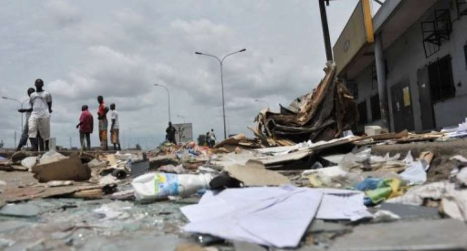 Resident walk past shops looted and destroyed in the Abobo district of Abidjan in 2011.  By Issouf Sanogo AFPFile