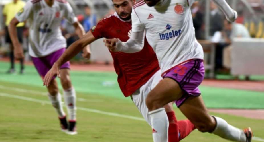 Al-Ahly's Ahmed Fathi L marks Wydad's Ismail El Haddad during their CAF Champions League match.  By Mohamed El-Shahed AFPFile