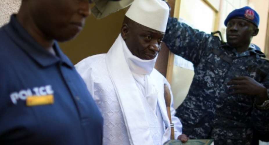 Yahya Jammeh (C) left the country in 2017 after losing the presidential election.  By MARCO LONGARI (AFP)
