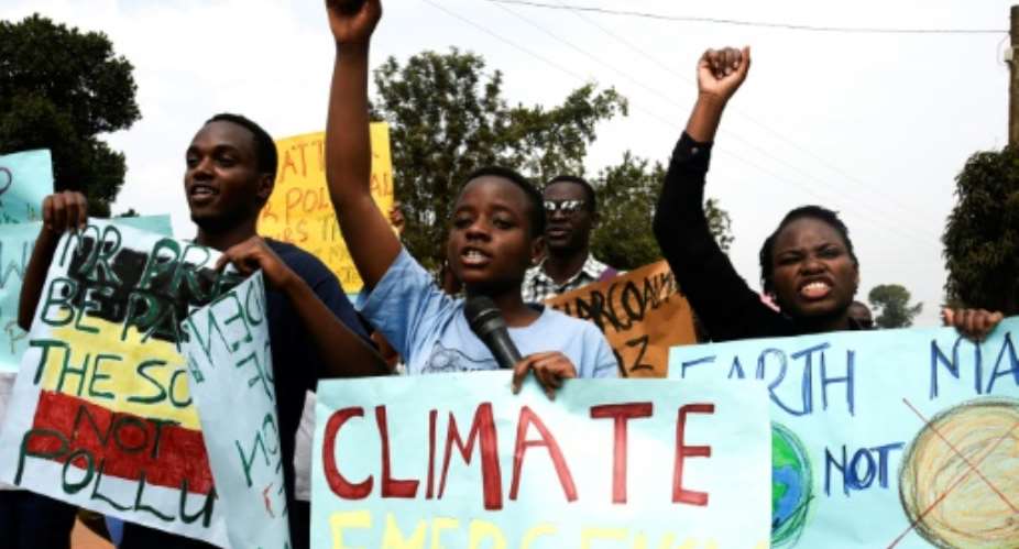 Young people took part in a march against climate change.  By ISAAC KASAMANI AFP