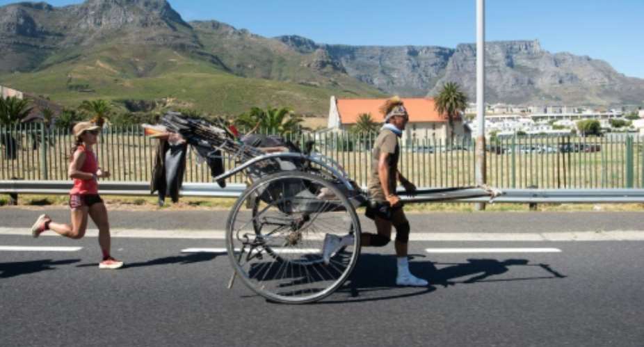 Yuji Gump Suzukis rickshaw weighs more than 100 kilograms (220 pounds).  By RODGER BOSCH (AFP)