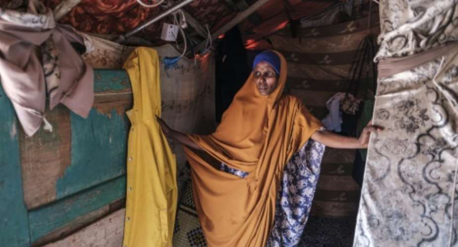 Yurub Abdi Jama, 35, lives in a makeshift shelter outside Hargeisa after losing all her livestock to drought and fleeing to the city.  By EDUARDO SOTERAS AFP