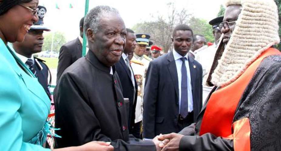 Michael Sata 2nd left is welcomed by the Speaker of the National Assembly Dr Patrick Matibini right before officially opening the Zambian Parliament on September 19, 2014 in Lusaka.  By Stringer AFP