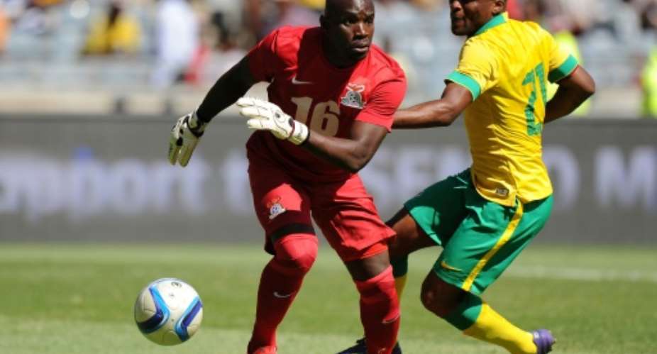 Zambian goalkeeper Kennedy Mweene L, pictured January 2015 had a howler that almost cost Zambia a qualifier against Guinea-Bissau.  By GORDON HARNOLS AFPFile