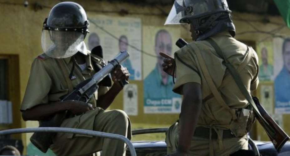 Tanzianian police patrol the streets of Mwembe Makumbi after violent protests across Zanzibar in 2005.  By Marco Longari AFPFile