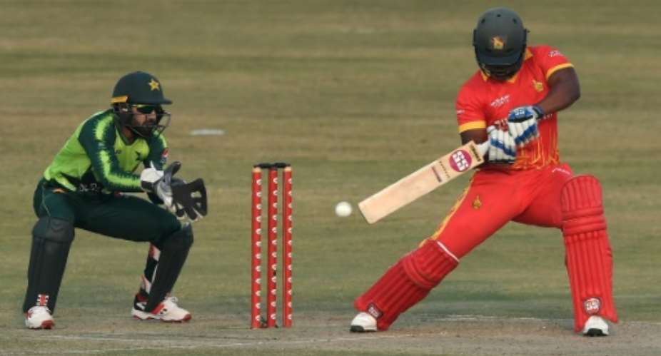 Zimbabwe captain Chamu Chibhabha plays a shot as Pakistan's wicketkeeper Mohammad Rizwan stands by during their third Twenty20 cricket match in Rawalpindi.  By Aamir QURESHI AFP