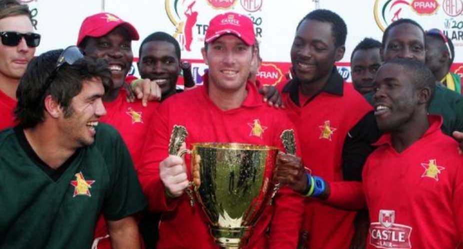 Zimbabwe team players pose with their trophy.  By Jekesai Njikizana (AFP)