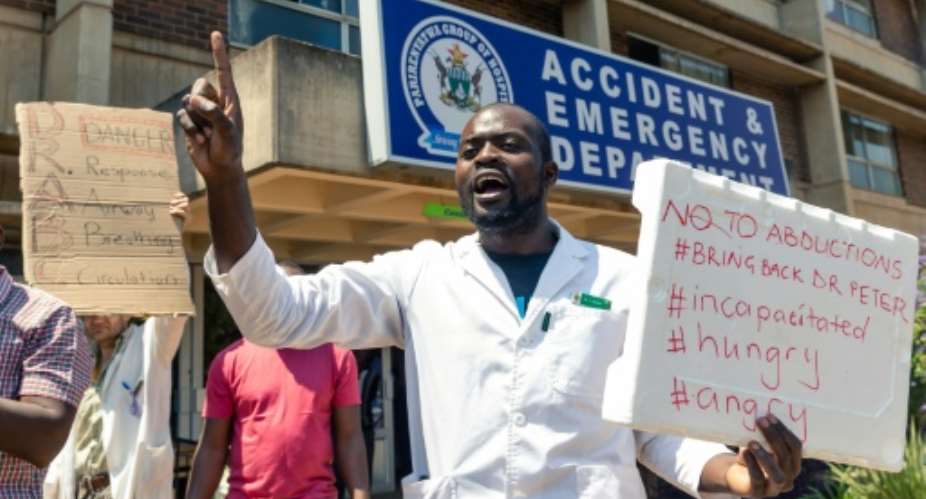Zimbabwe doctors have taken to the streets to protest the suspected kidnapping of one of their labour leaders.  By Jekesai NJIKIZANA AFP