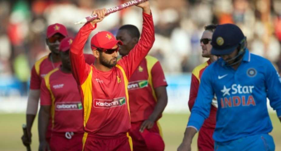 Zimbabwe stand-in captain Raza Butt L salutes the crowd after securing a victory during the second and final game in a series of two Twenty20 international matches between Zimbabwe and India on July 19, 2015 in Harare.  By Jekesai Njikizana AFPFile