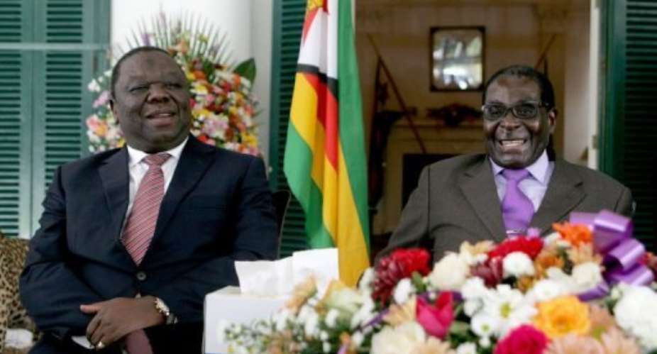 Zimbabwe's President Robert Mugabe R and Prime Minister Morgan Tsvangirai L, pictured on January 17, 2013 in Harare.  By Jekesai Njikizana AFPFile