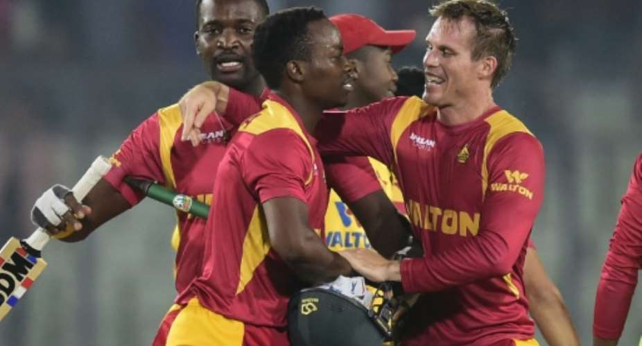 Zimbabwe's Neville Madziva 2nd left and Malcolm Waller celebrate after helping their team to victory over Bangladesh in the second T20 international in Dhaka, on November 15, 2015.  By Munir Uz Zaman AFP