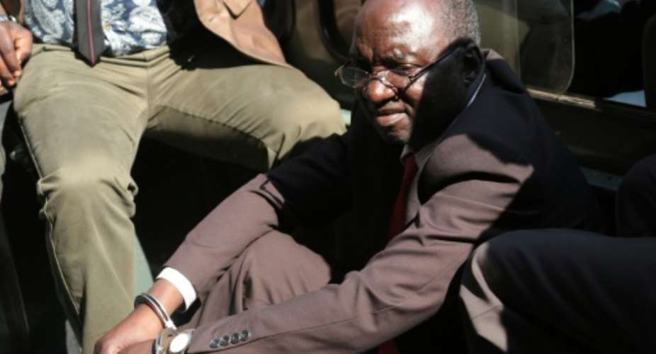 Zimbabwe War Veterans spokesman Douglas Mahiya arrives handcuffed at Harare Magistrate Court on July 29, 2016 in Harare.  By Wilfred Kajese AFP