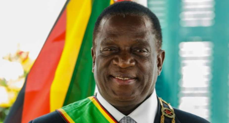 Zimbabwean President Emmerson Mnangagwa poses for photographs ahead of his maiden address to parliament. The opposition staged a boycott, saying his election was illegitimate.  By Jekesai NJIKIZANA AFP