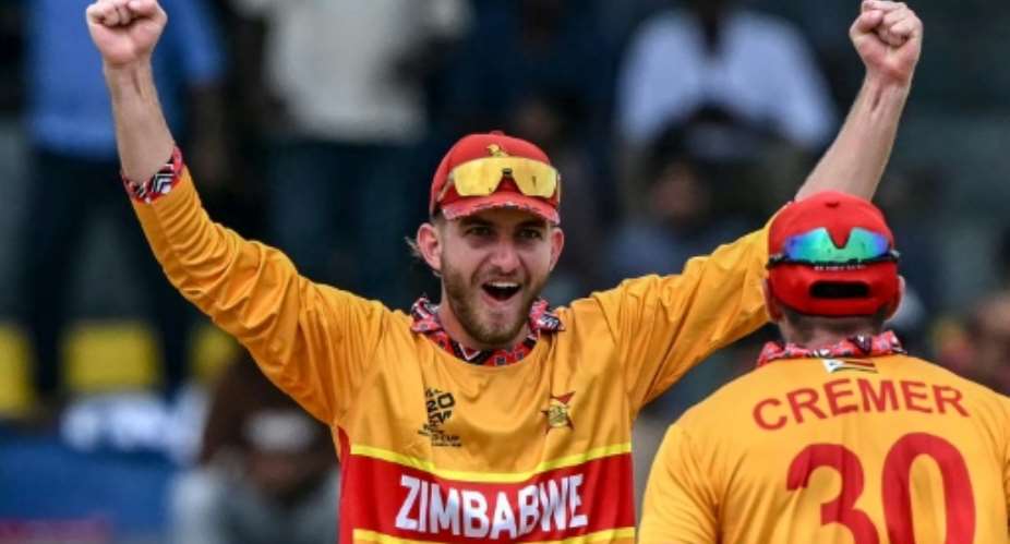 Zimbabwes Brian Bennett (L) celebrates with teammate Graeme Cremer after their teams win against Australia.  By Ishara S. KODIKARA (AFP)