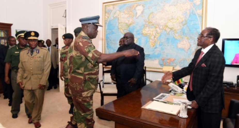Zimbabwe's Commander Airforce and Air Marshal Perence Shiri meets with Zimbabwe's President Robert Mugabe R on November 19, 2017, in Harare.  By  ZIMPAPERS IMAGESAFP