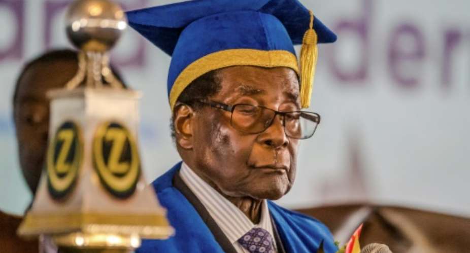 Zimbabwe's embattled President Robert Mugabe delivers a speech at a  university graduation ceremony, making a defiant first public appearance since the military takeover.  By Jekesai NJIKIZANA AFPFile