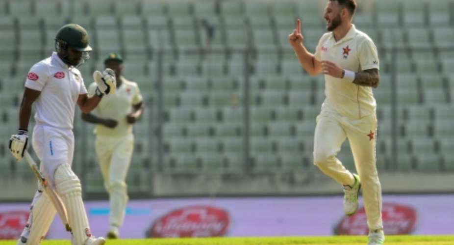 Zimbabwe's Kyle Jarvis R celebrates after the dismissal of Bangladesh opener Imrul Kayes L during the first day of the second Test.  By MUNIR UZ ZAMAN AFP