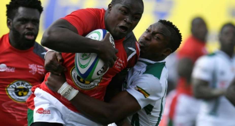 Zimbabwe's Lenience Tambwera R tackles Kenya's Isaac Adimo during the 2018 Rugby African Gold Cup match in Nairobi on June 30, 2018, which acts a qualifier for the 2019 Rugby World Cup in Japan.  By SIMON MAINA AFP
