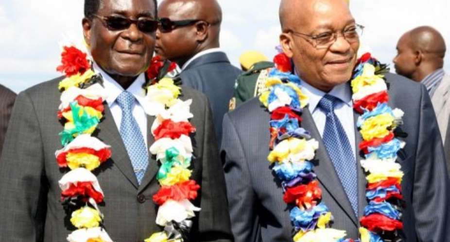 Robert Mugabe left with Jacob Zuma at Harare International airport in 2010.  By Jekesai Njikizana AFP