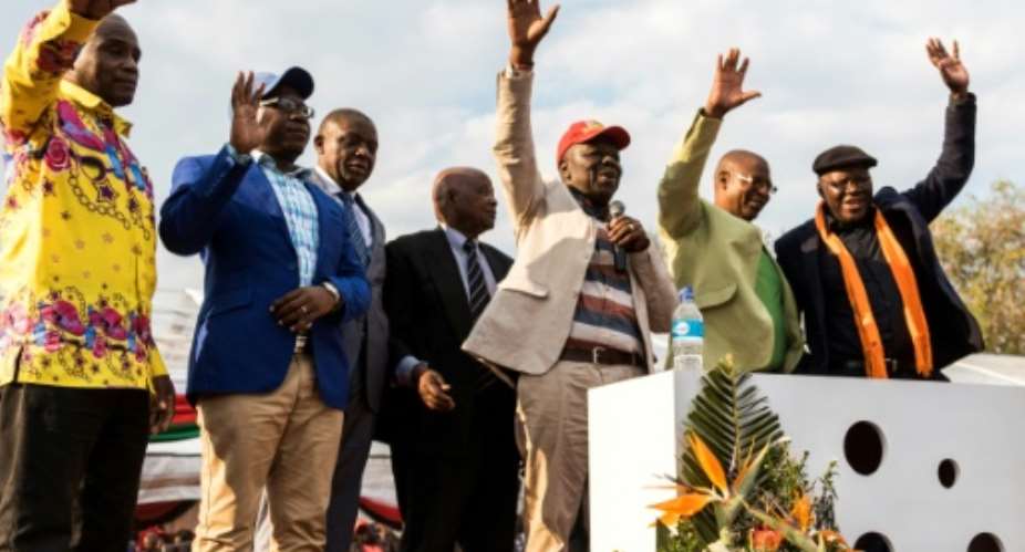 Zimbabwe's opposition joined forces on Saturday in a bid to unseat Robert Mugabe from power next year.  By Jekesai NJIKIZANA AFP