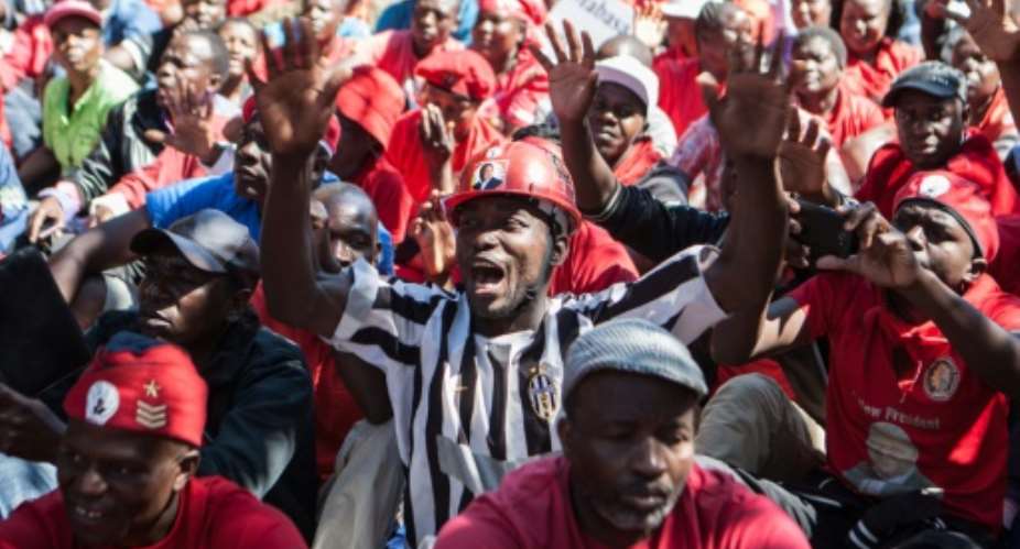 Zimbabwe's opposition party Movement for Democratic Change MDC supporters shout anti-government slogans during a demonstration in Gweru, on August 13, 2016.  By Zinyange Auntony AFP