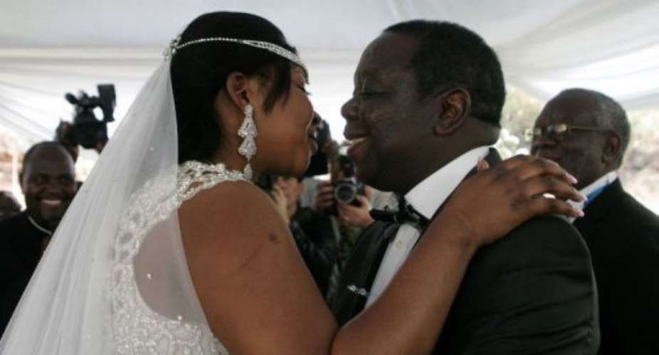 Zimbabwe Prime Minister Morgan Tsvangirai R kisses his wife Elizabeth Macheka.  By Jekesai Njikizana AFP