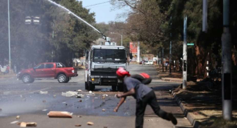 Zimbabwe's President Robert Mugabe accused foreign powers of having a hand in the unrest which saw opposition supporters clash with police in Harare.  By Wilfred Kajese AFP