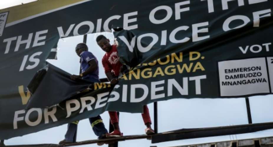Zimbabwe's presidential election has left deep scars. In this August 1 picture, supporters of the opposition MDC rip an electoral poster for the ruling ZANU-PF.  By Luis TATO AFP