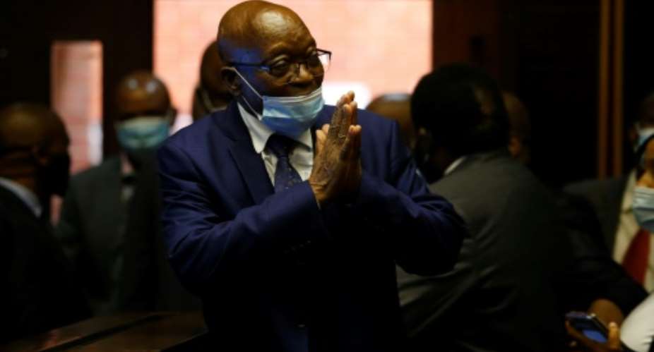 Zuma greeting supporters in the gallery of the High Court in Pietermaritzburg in May.  By ROGAN WARD POOLAFP