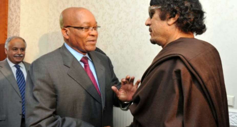 Zuma, left, pictured with Kadhafi on May 30 2011, when he made a one-day visit to Tripoli as head of an African Union delegation mediating in the Libyan crisis. Zuma has denied a newspaper report that he was given 30 million by Kadhafi for 'safe keeping'.  By Ntswe Mokoena South African governmentAFP