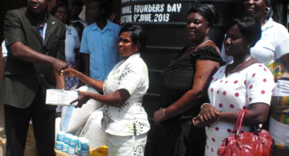 Apostle Lepold Kwartei presenting the items recieved by Mrs. Gladys Nartey on behalf of Osu Children home.