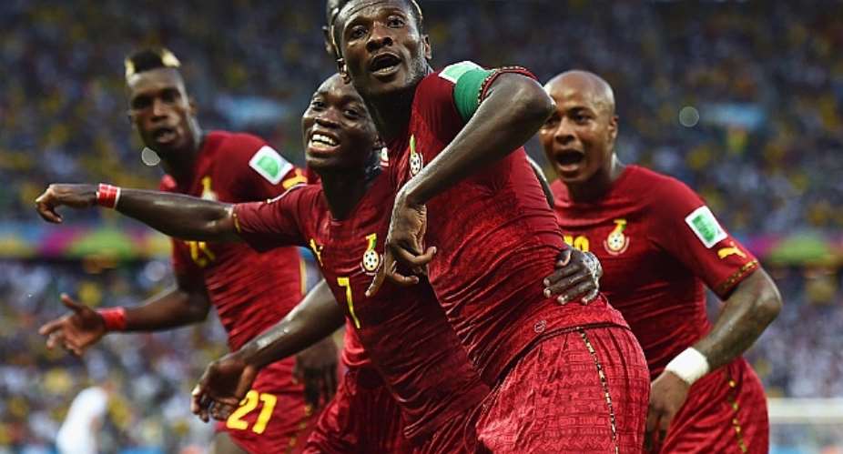 Asamoah Gyan of Ghana celebrates scoring with his teammates