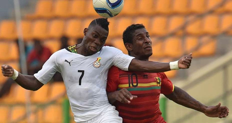 Ghana's Christian Atsu L vies with Guinea's Kevin Constant R