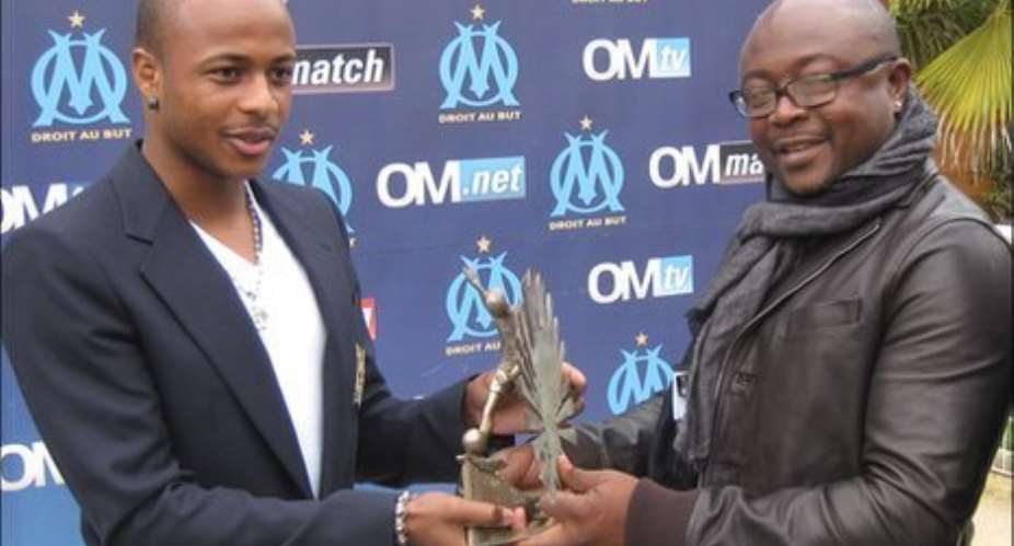 Ghana winger Andre Ayew with his father receiving an award in France