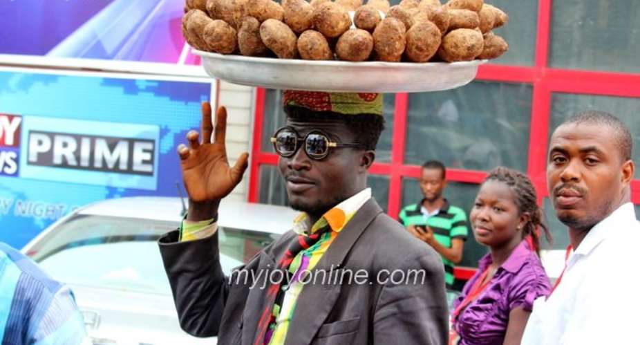 Photo of the week: Meet Ebenezer, a suited cocoyam seller