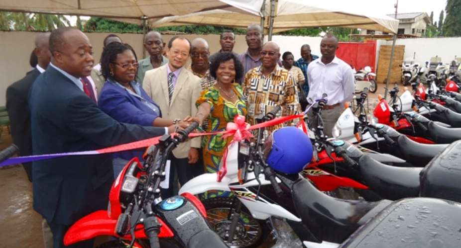 Mr. Stephen Adu, Dep. D-G of GES (first left) receiving the motobikes from Mr. Koichi Kito of JICA, while other GES officials assist  in the process