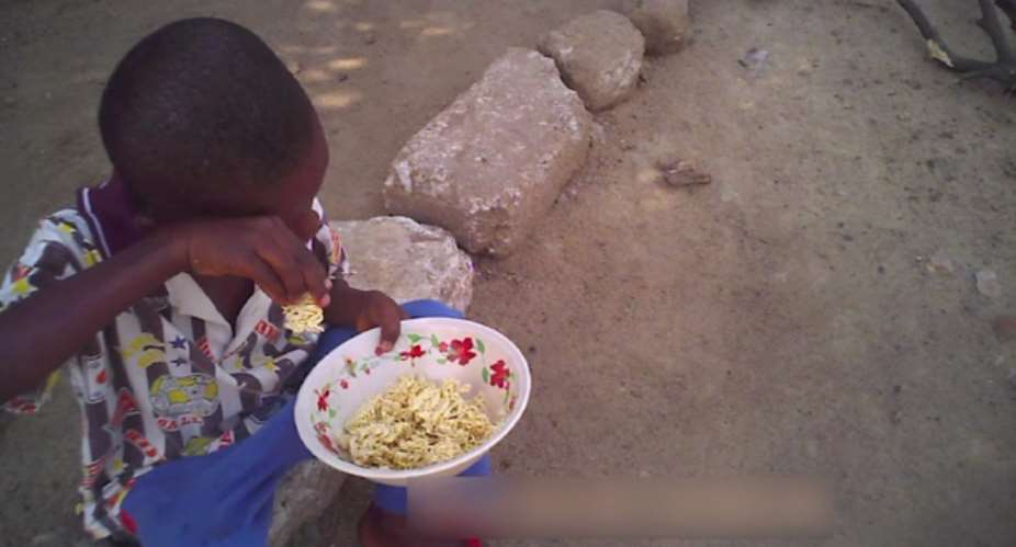 BOY EATING UNCOOKED INDOMIE FOR LUNCH