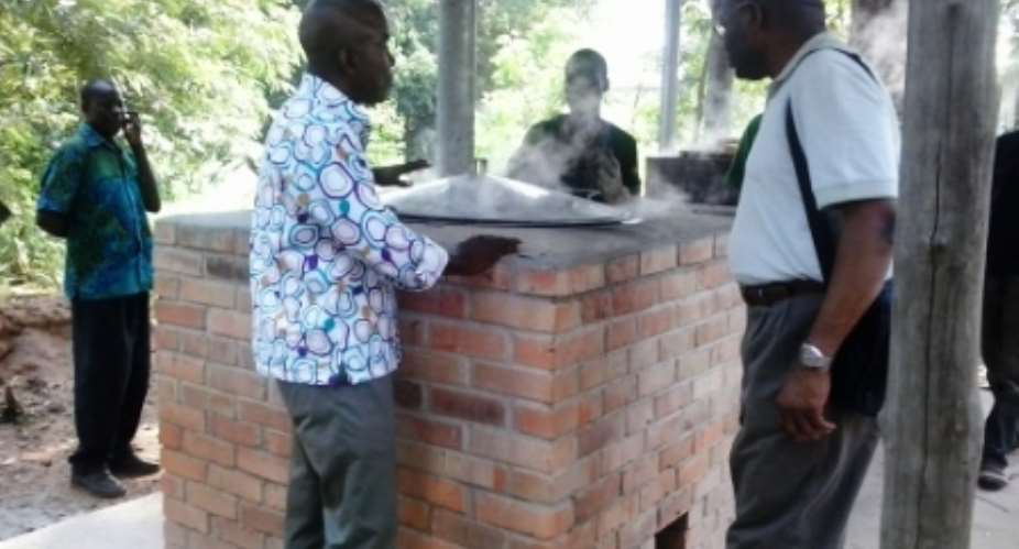 Mike commey showing one of his cookstove technologies