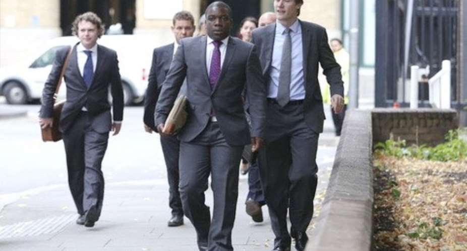 Former UBS trader Kweku Adoboli, center, arrives at Southwark Crown Court in London. Photographer: Chris RatcliffeBloomberg