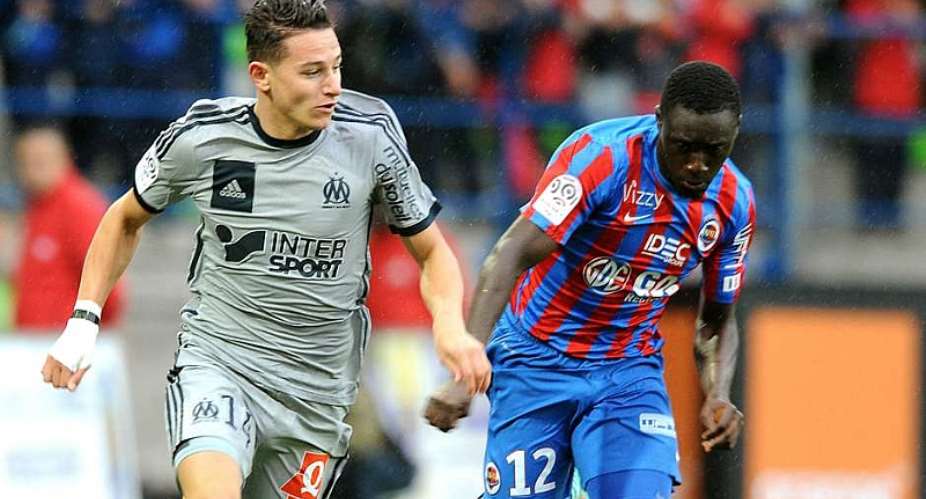 Dennis Appiah in a challenge against Flauvin Thauvin assisted a goal for Caen
