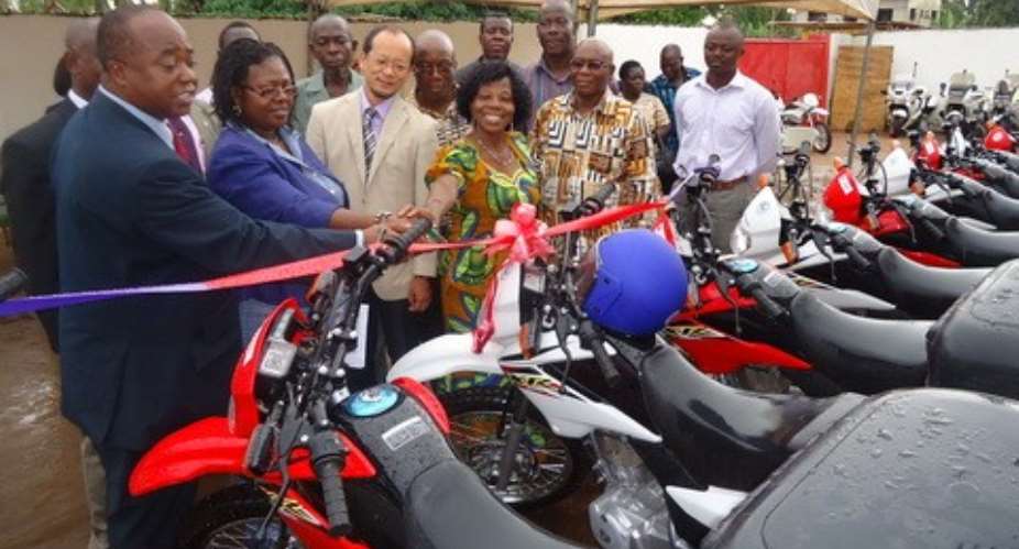 Mr. Stephen Adu, Dep. D-G of GES first left receiving the motobikes from Mr. Koichi Kito of JICA, while other GES officials assist in the process