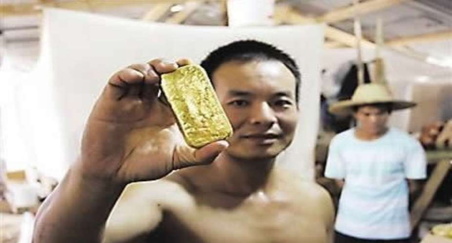 A Shanglin man holding a gold medallion.