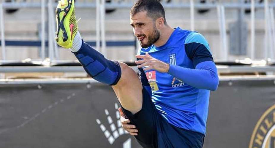 Japans left looks alright to Dimitris Salpingidis of Greece