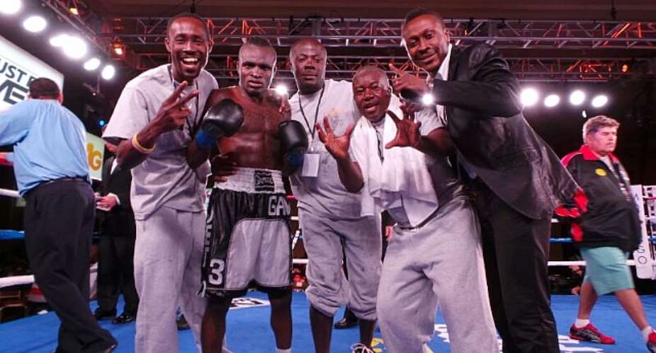 Emmanuel Tagoe with his trainers and manager Baffour Gyan after the fight
