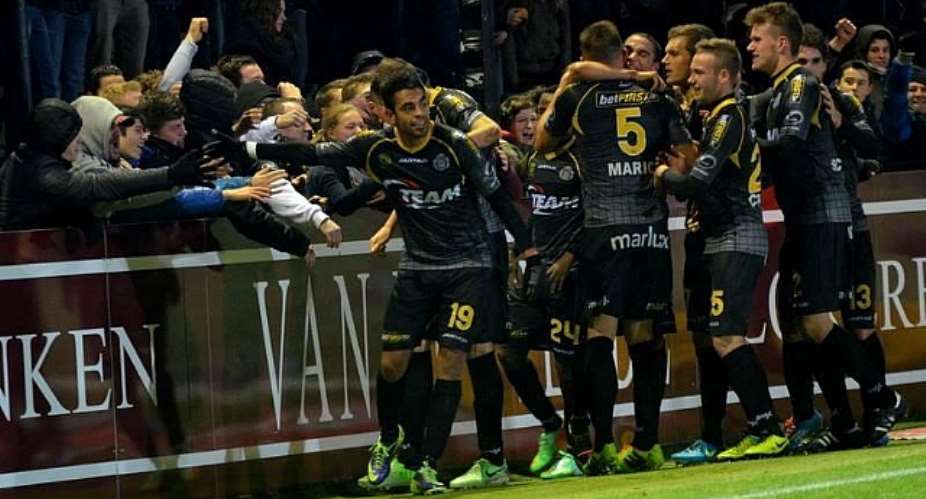 Eugene Ansah mobbed by team-mates as he celebrates his goal for Lokeren