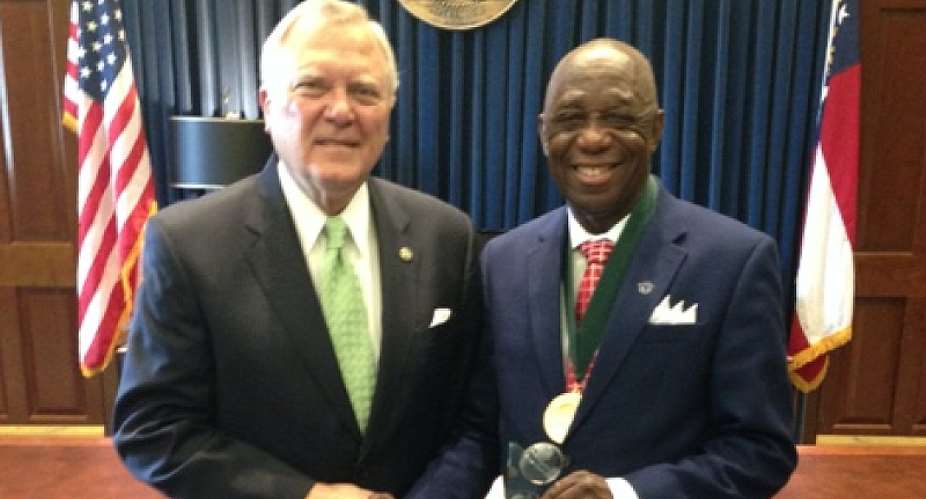 Dr. Mensah Right With The NAI Plaque Congratulated By Governor Deal Of Georgia