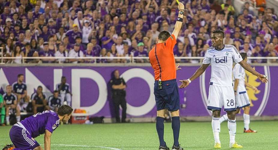 Gershon Koffie is being shown a yellow card by a referee: Photograph – Orlando City FC Facebook Page